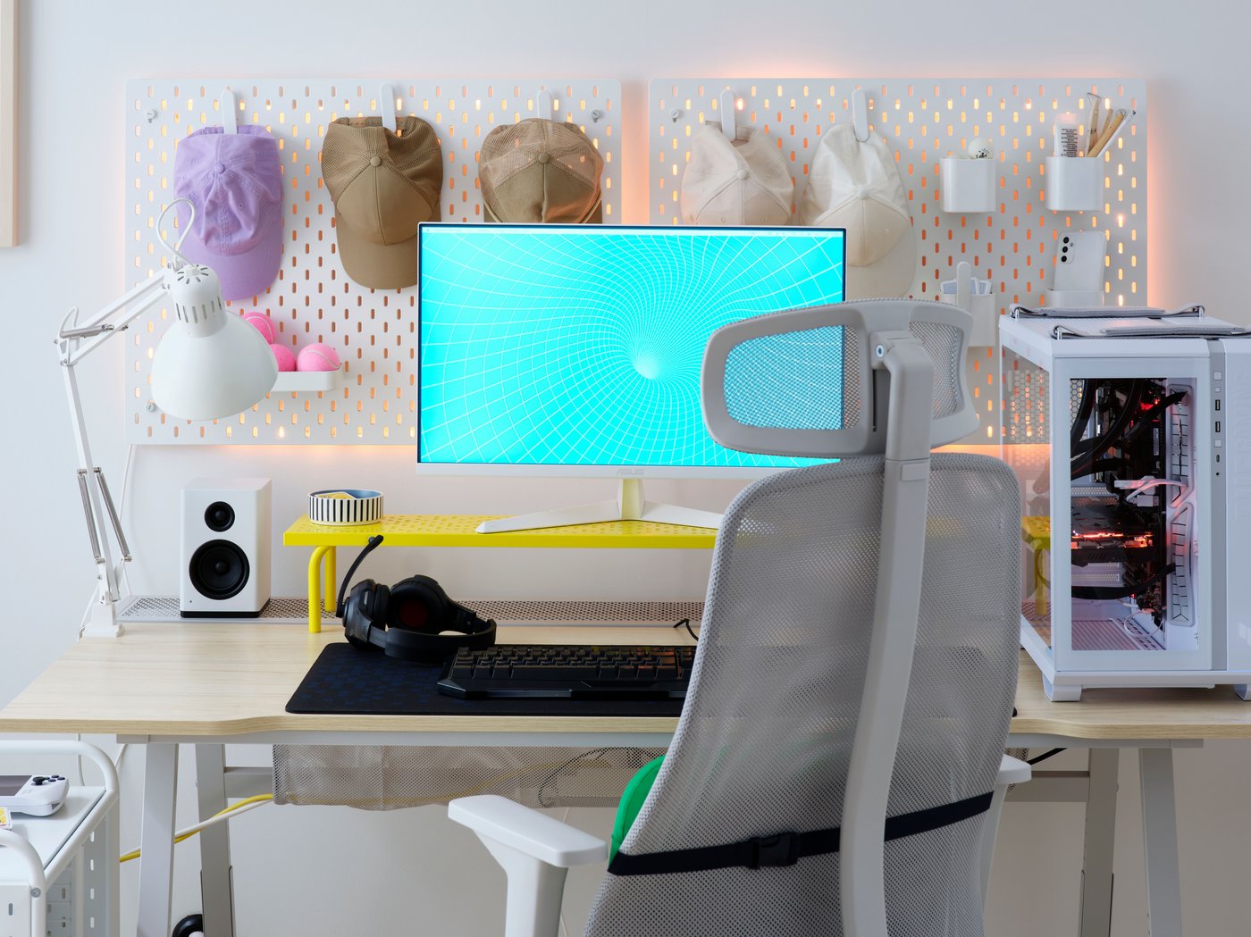 A bright, airy and tidy UTESPELARE ash effect gaming desk has two white SKÅDIS pegboards on the wall behind a monitor.
