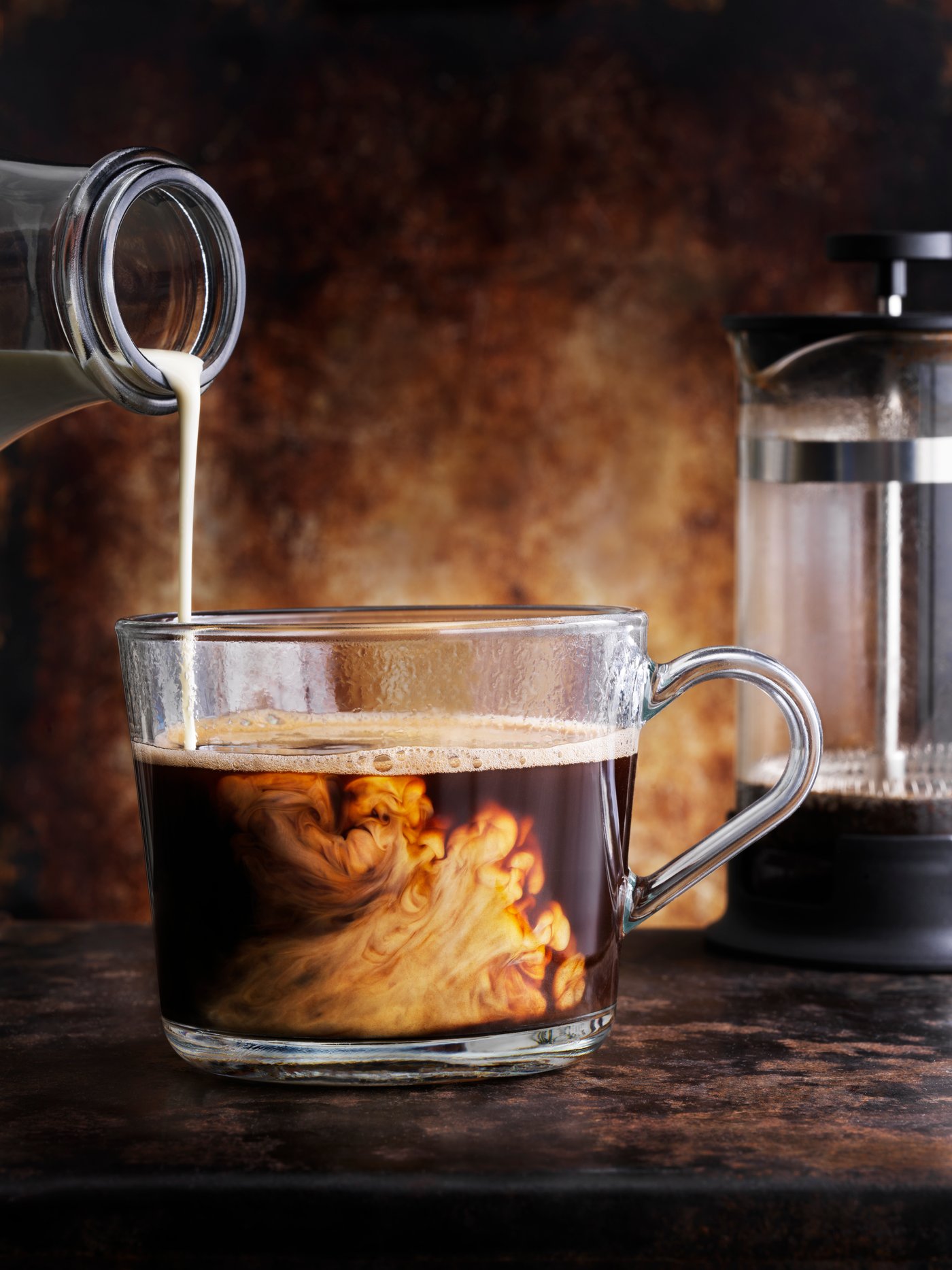 Milk is served with a cup of coffee.