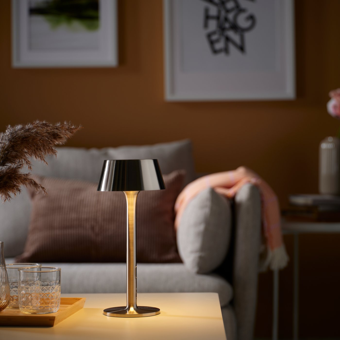 A battery-operated dimmable/nickel-plated outdoor AVHÅLL LED portable lamp in the living room