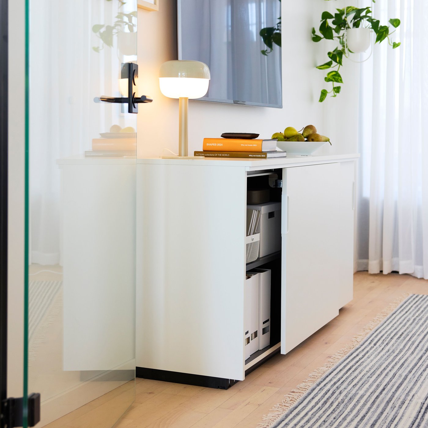 An in/outdoor white CHILISTRÅN hanging planter in the home office