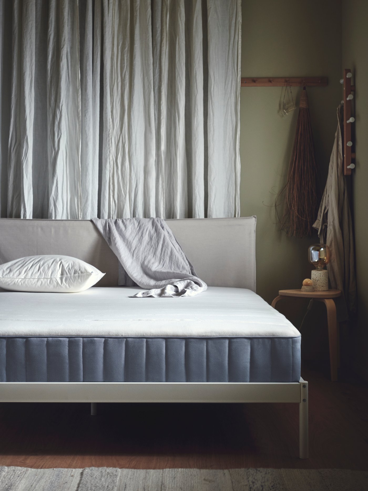 A firm/light blue VESTERÖY pocket sprung mattress in the bedroom.