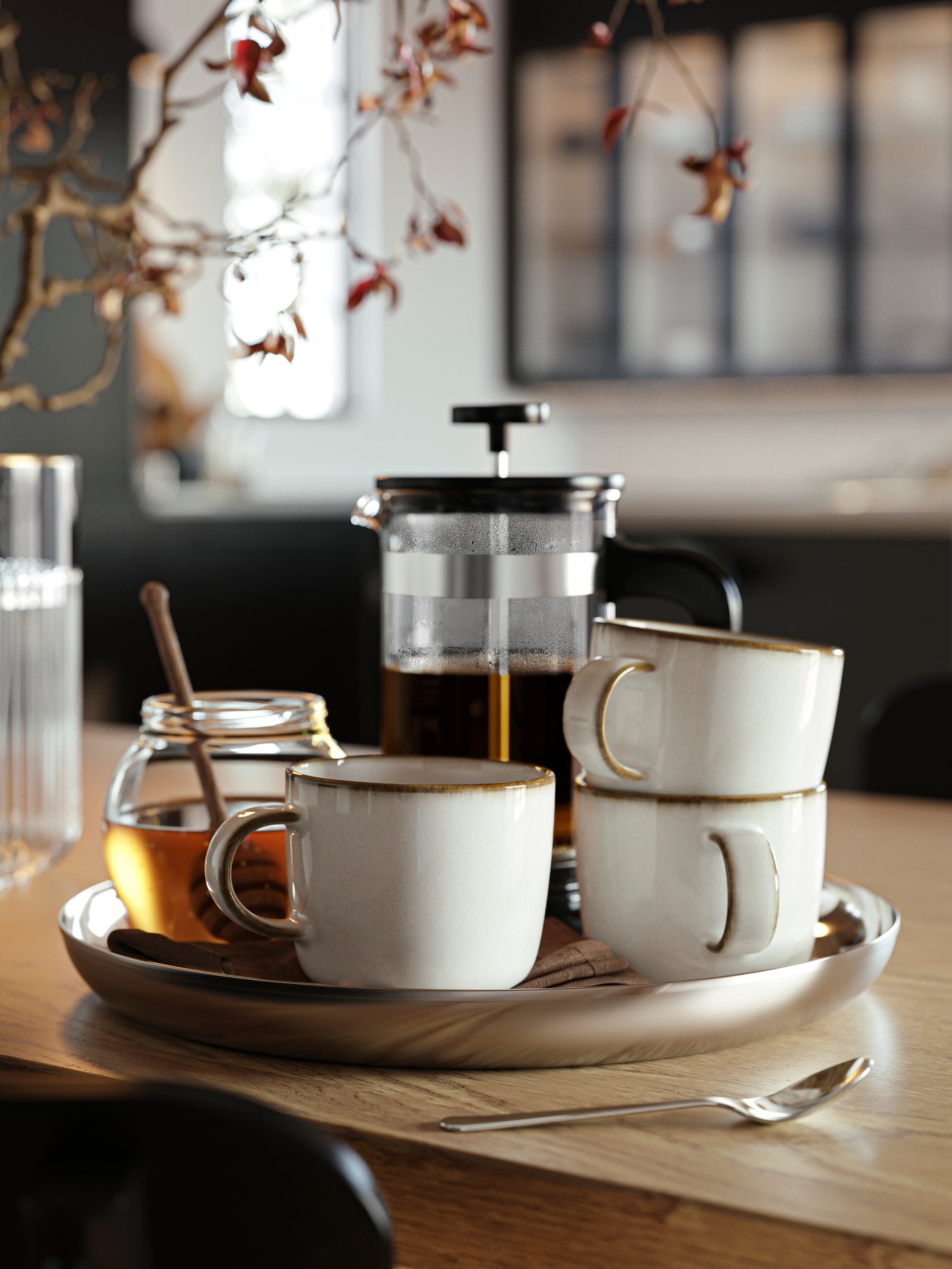 A TUVHÄTTA serving plate in stainless steel with an UPPHETTA coffee/tea maker in stainless steel and glass and GLADELIG mugs.