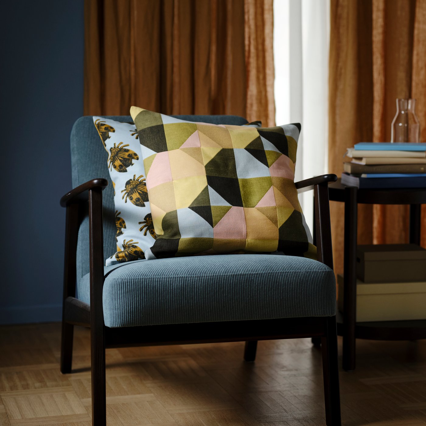 A Kelinge grey-turquoise EKENÄSET armchair in the living room