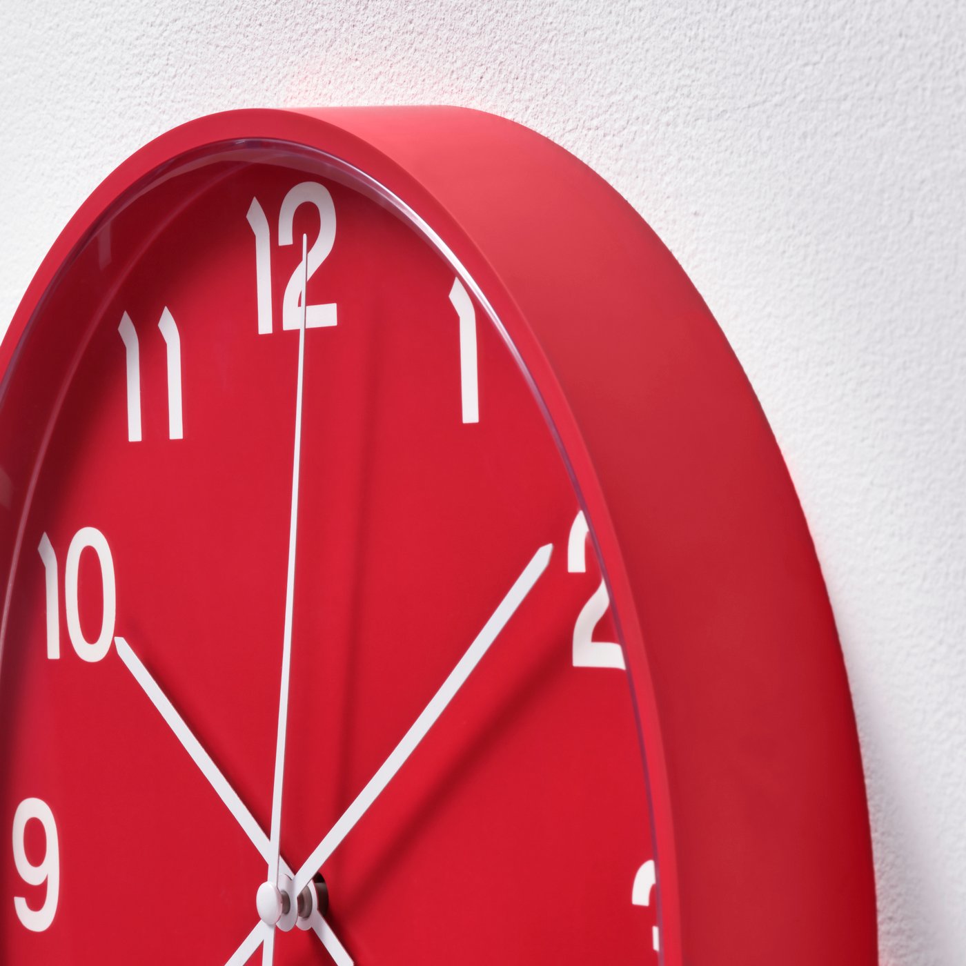 A red PLUTTIS wall clock