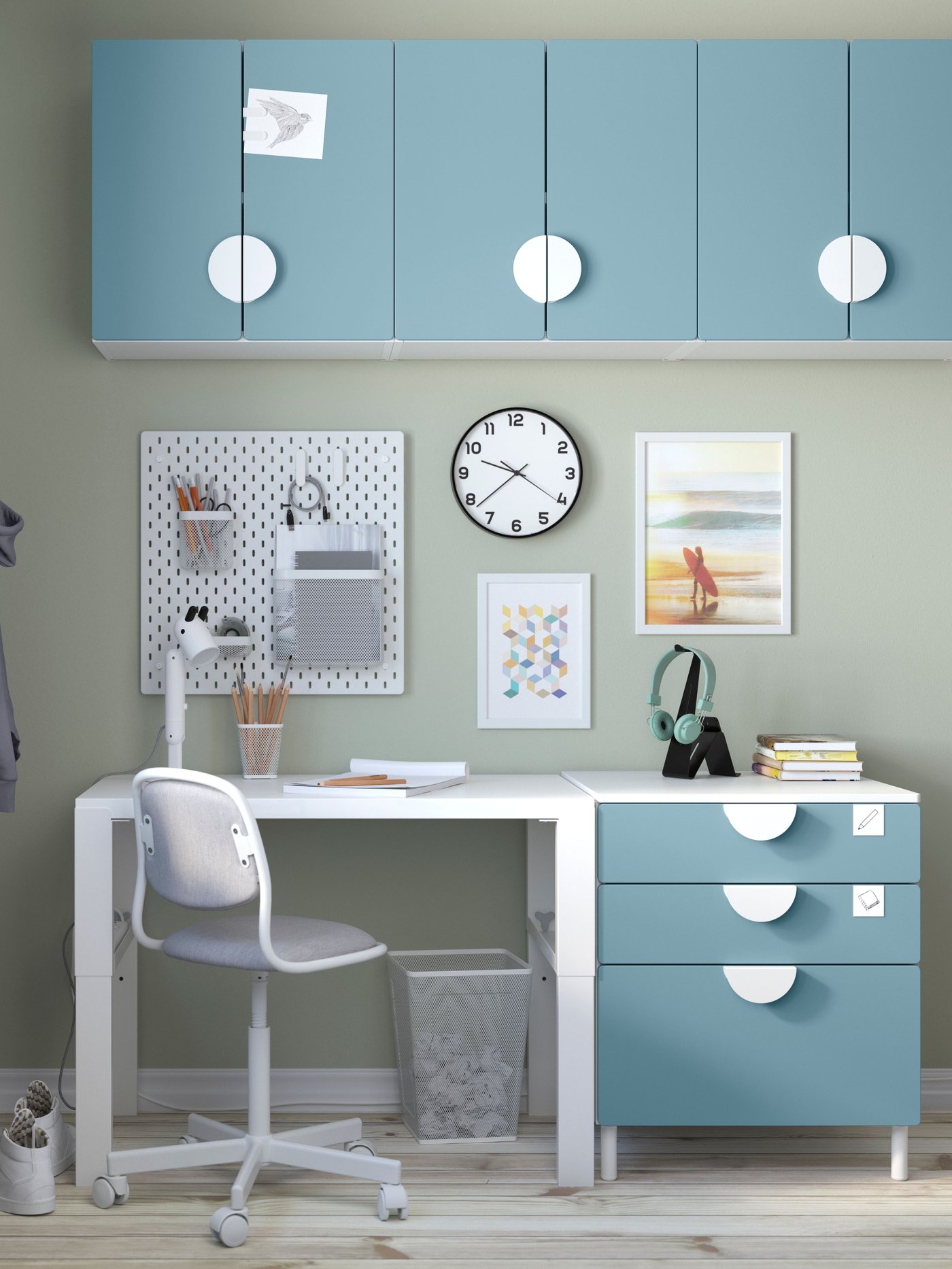 IKEA SMÅSTAD white desk with blue drawer cabinets next to it and on the walls.