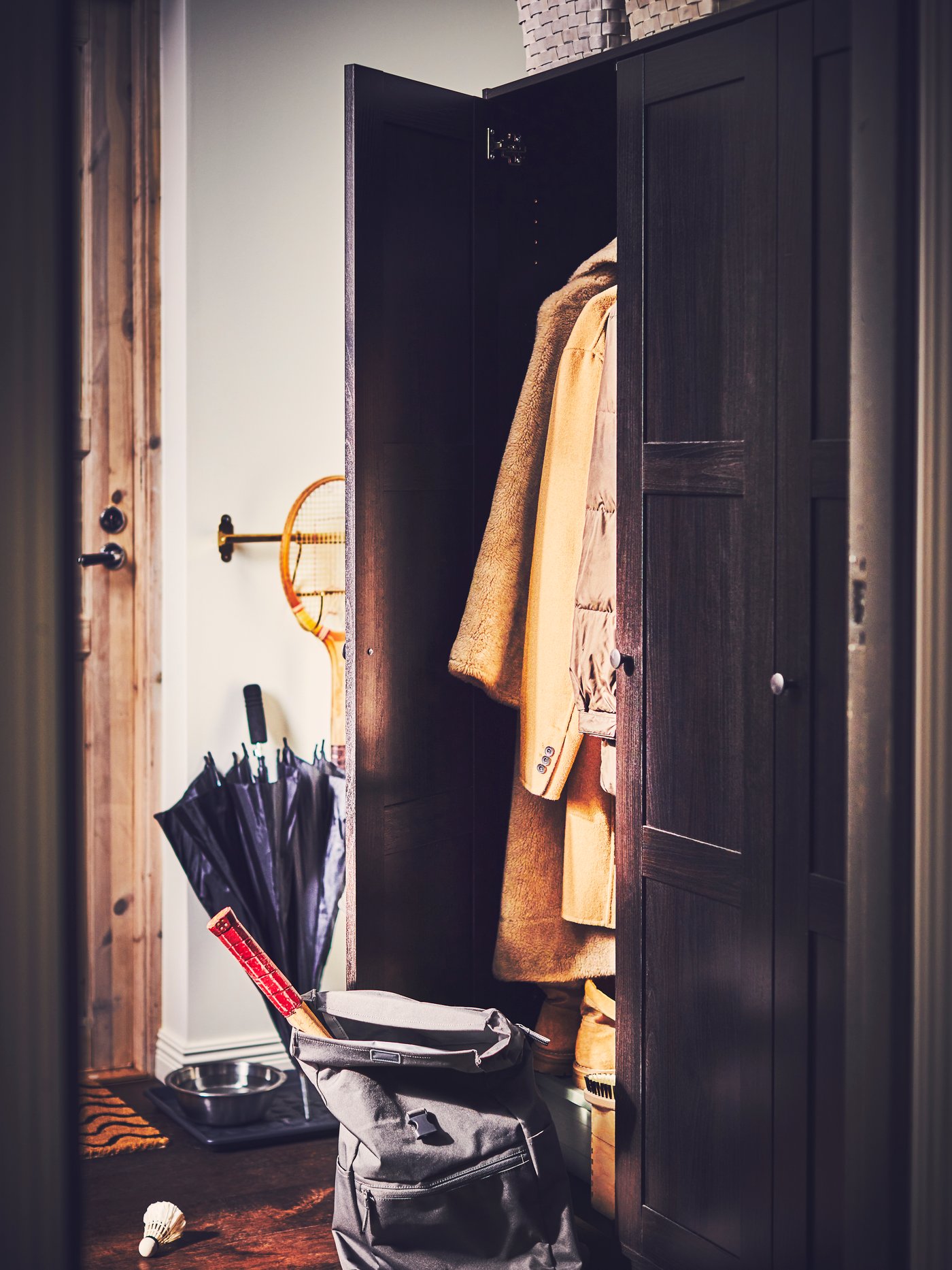 A polished/brass-colour HULTARP kitchen roll holder in the hallway
