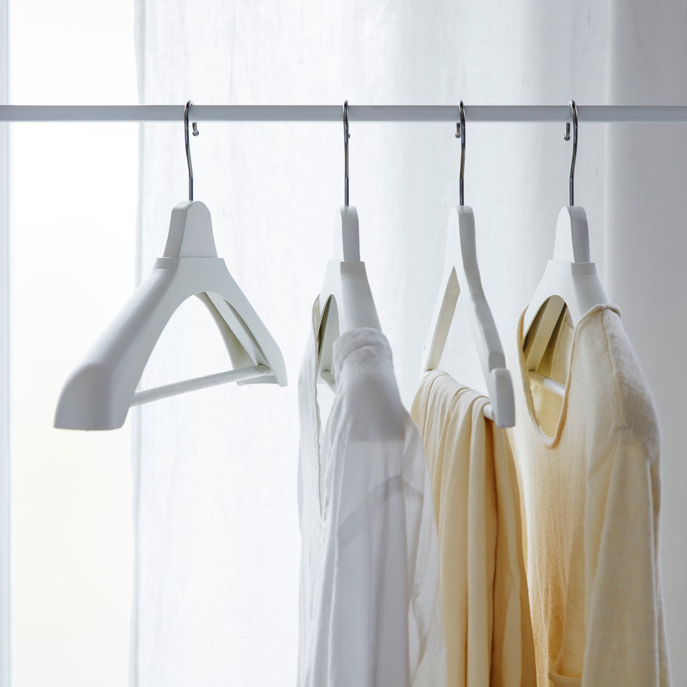 A white BUMERANG shoulder shaper for hanger