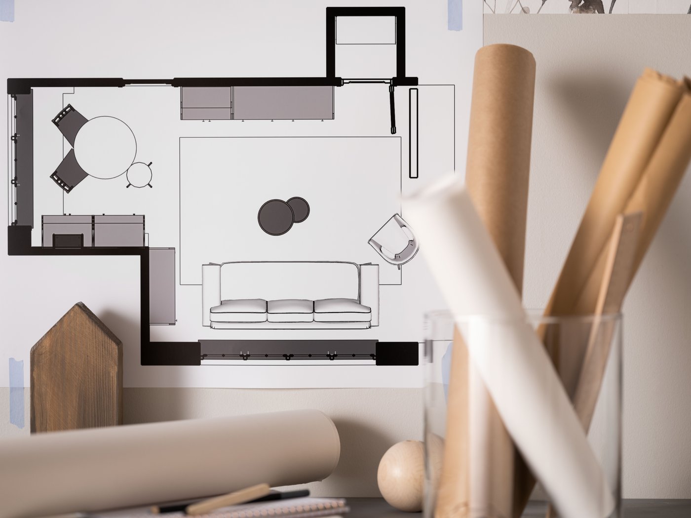 A light desktop with scattered but symmetrically arranged office accessories and desk-work paraphernalia.