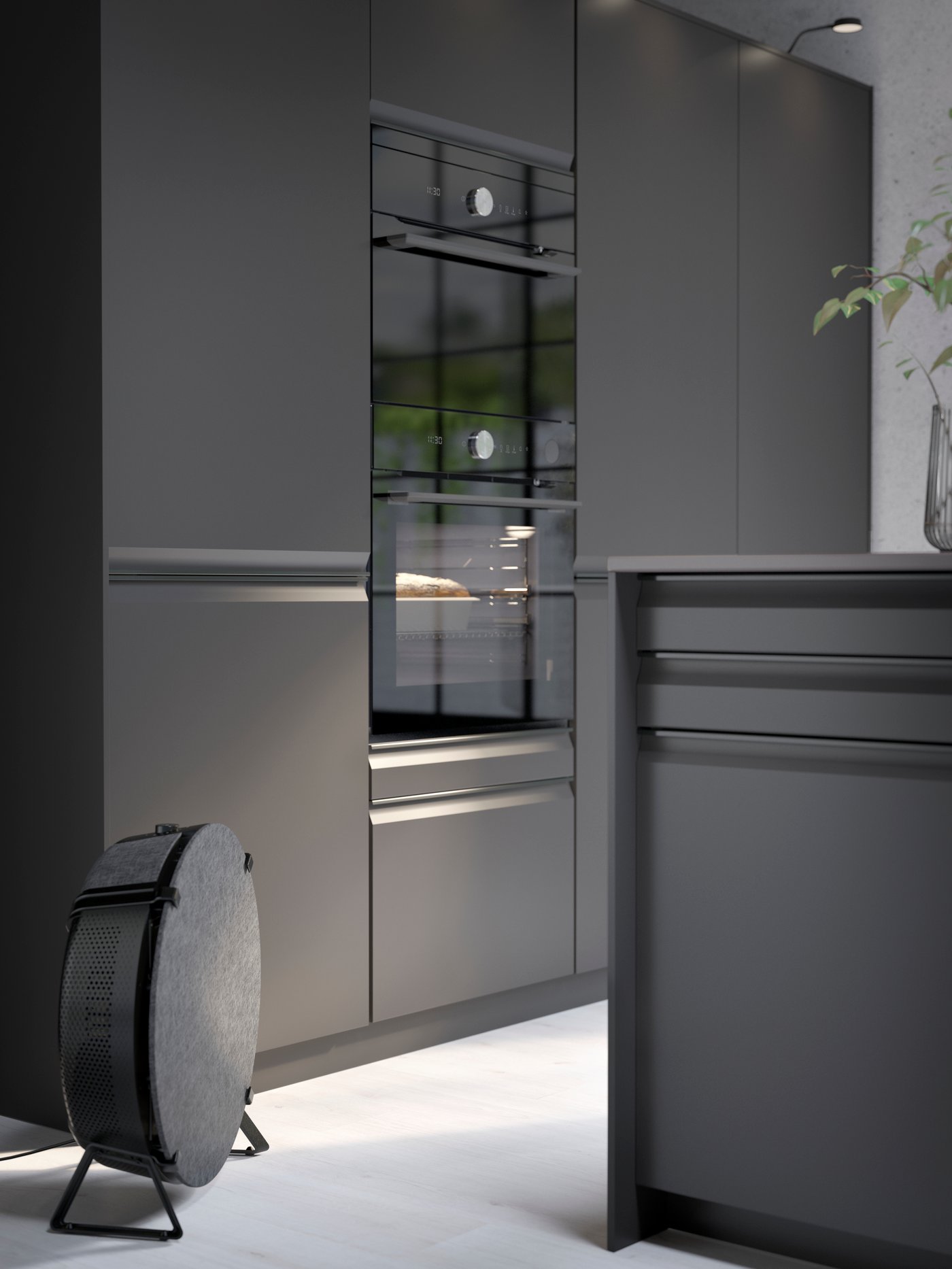 A kitchen with UPPLÖV doors and drawer fronts in anthracite, a STARKVIND smart air purifier in black and kitchen appliances.