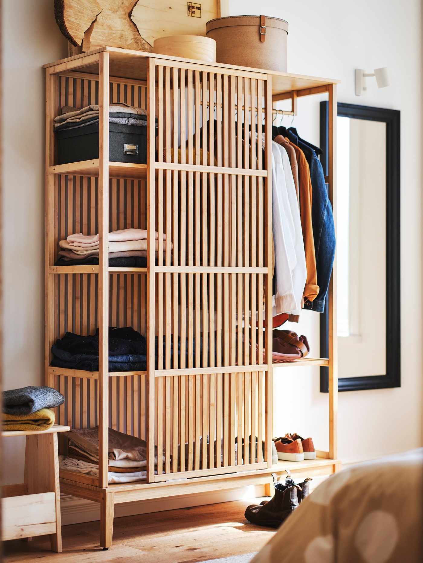 A pine PERJOHAN stool with storage in the bedroom