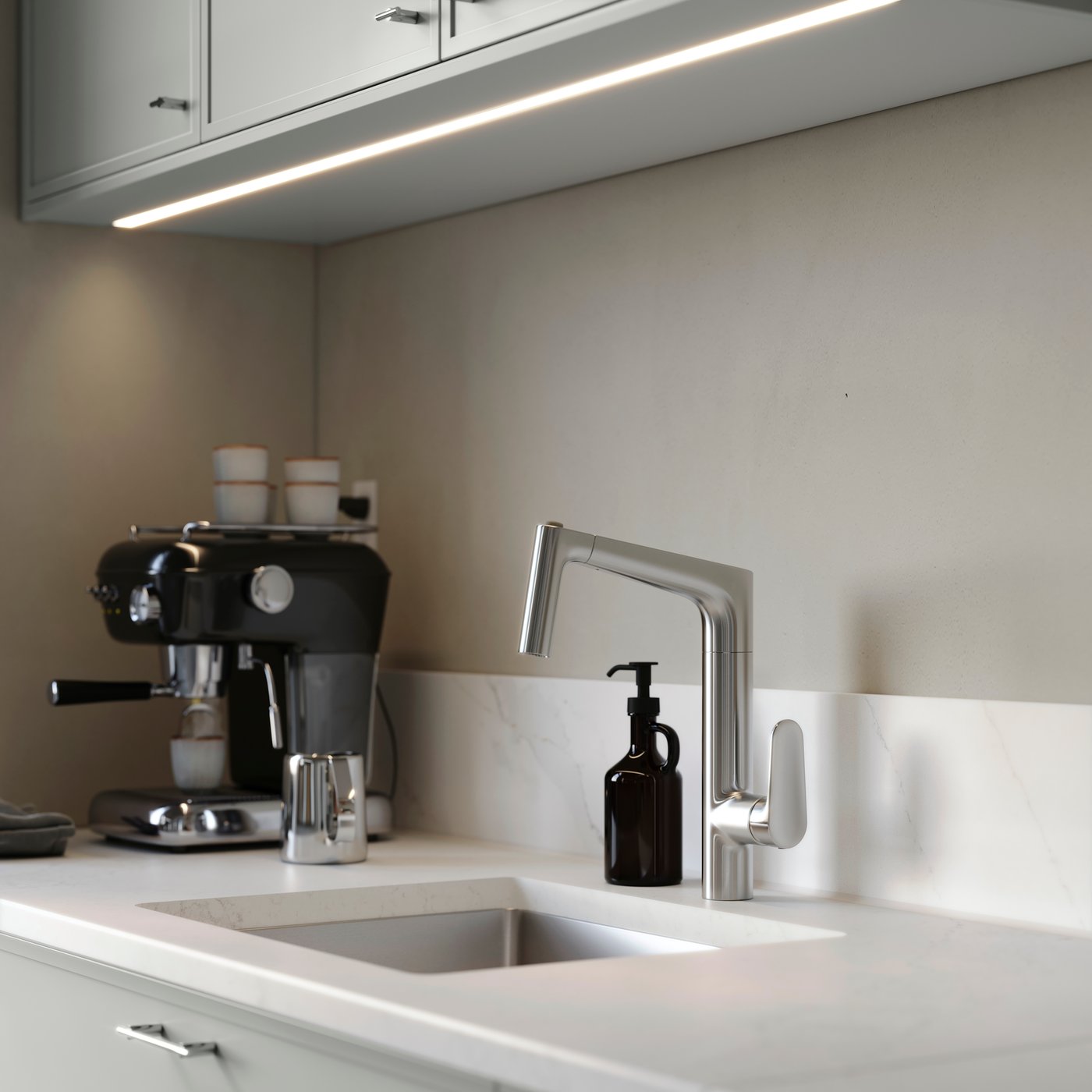 MAJSJÖN kitchen mixer tap pull out with spray, placed above a sink with white worktop and a coffee machine.