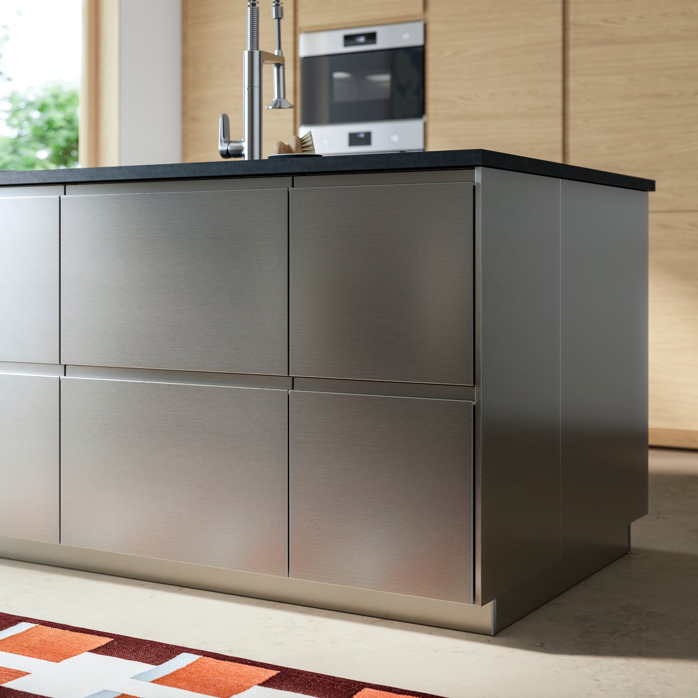 Close up of a kitchen island in a modern minimalist kitchen highlighting VOXTORP stainless steel effect drawer fronts.