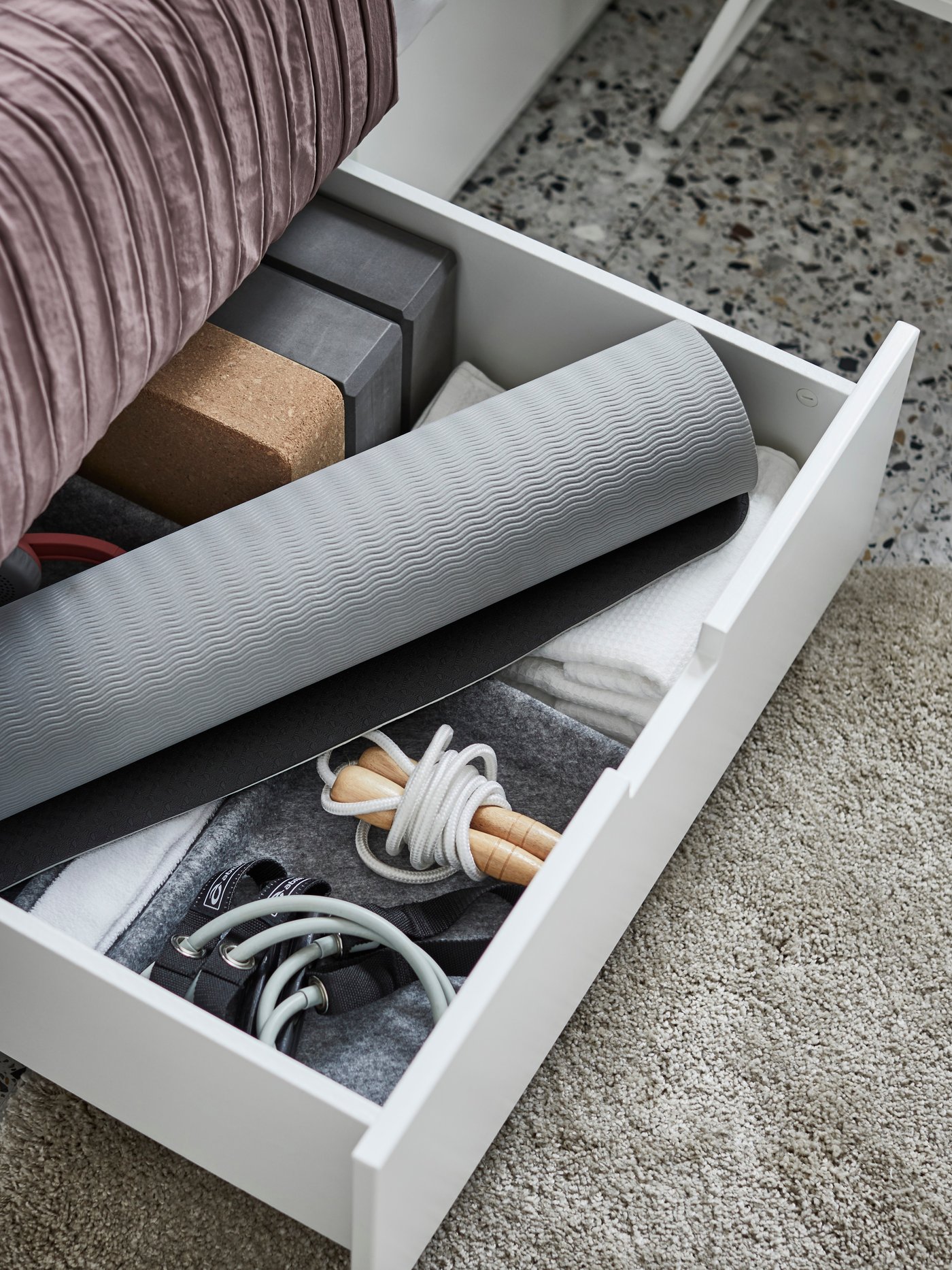 A NORDLI bed with storage with BERGPALM bed linen stands in a bedroom near a NORDKISA open wardrobe with sliding door.