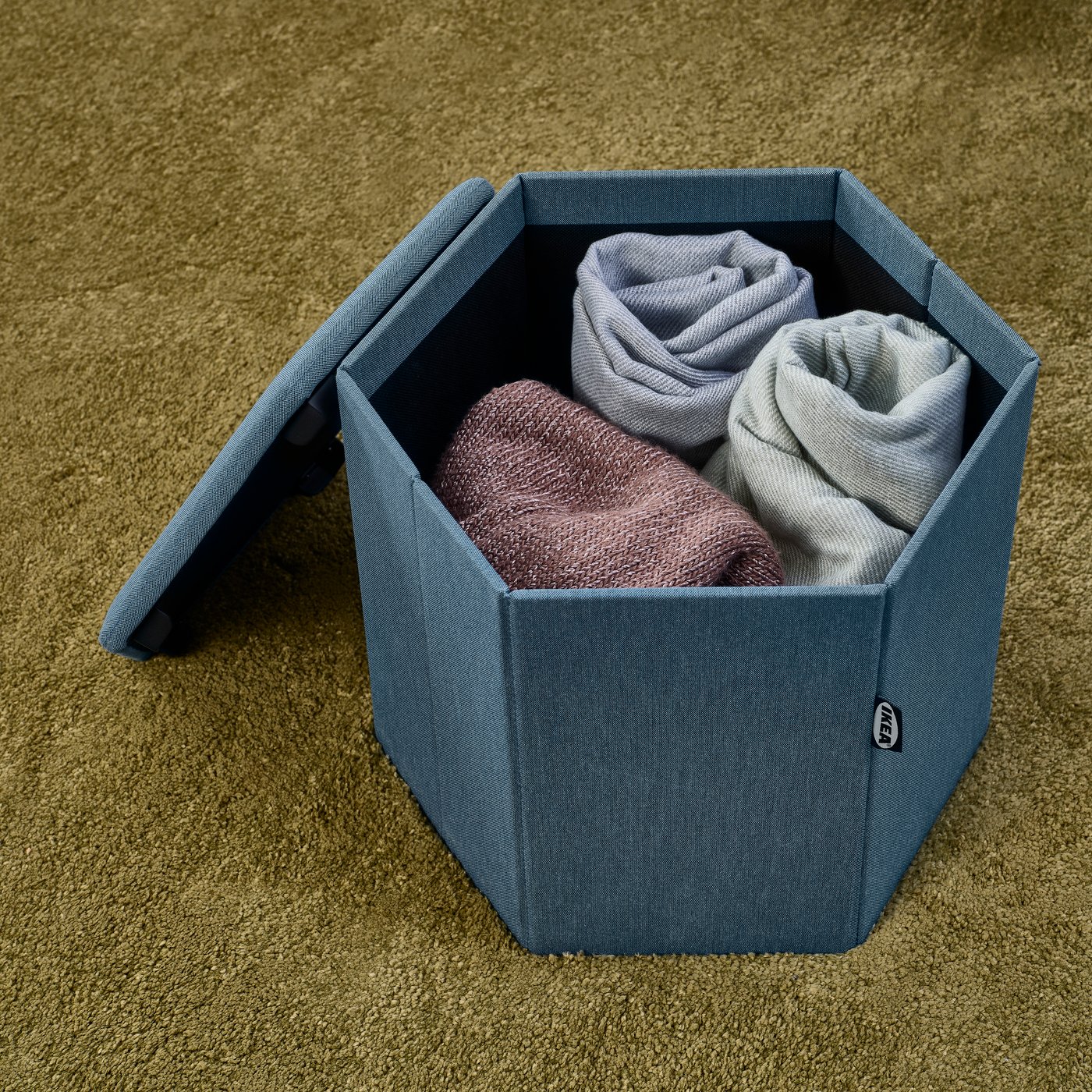 A Knisa medium blue KJUGE pouffe with storage