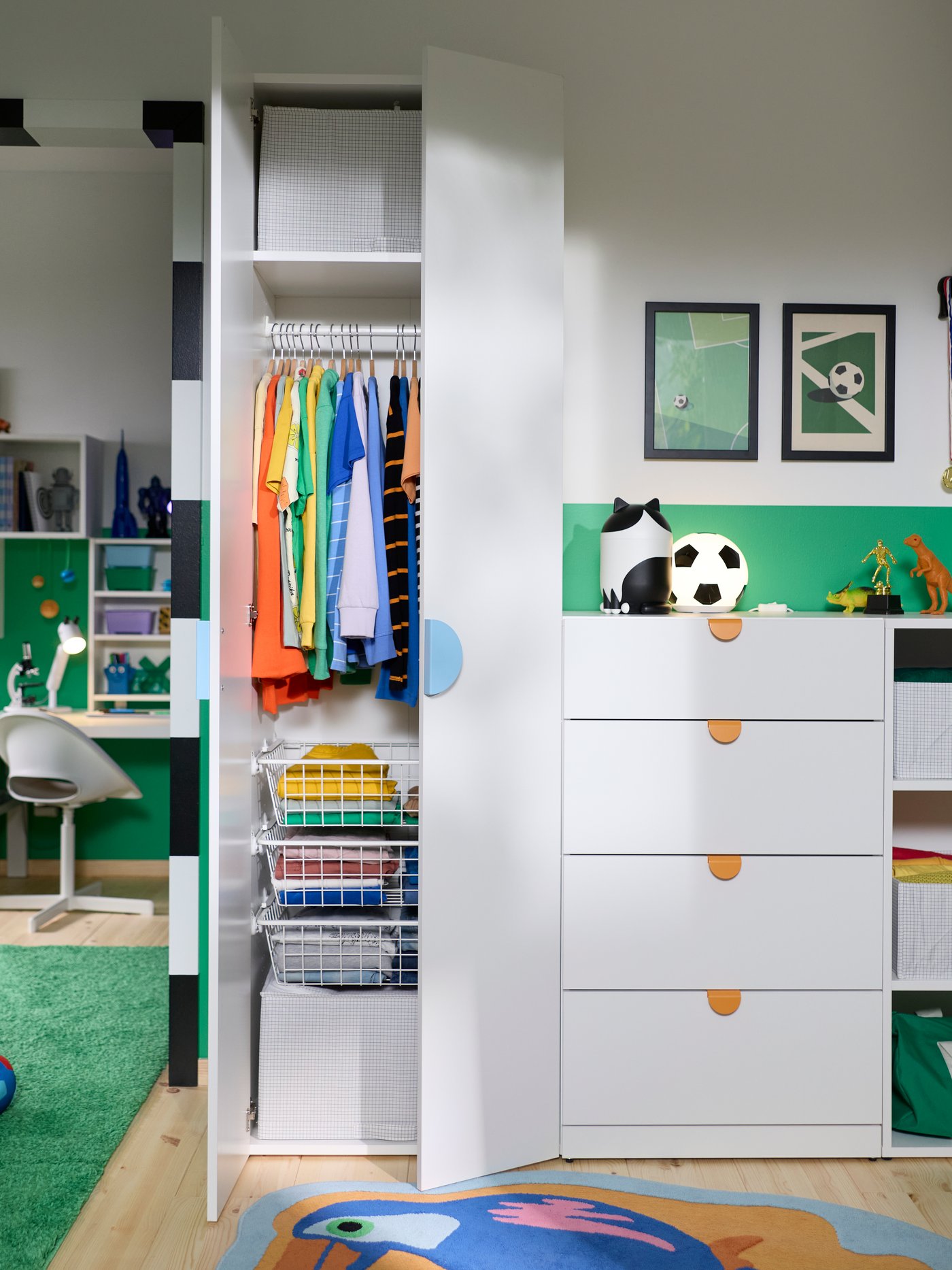 A kids’ room with a LASTARE wardrobe combination with storage, hanging rail and drawers next to a workspace and play area.