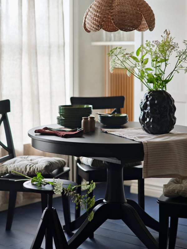 A handmade/rattan SANDKORN pendant lampshade in the dining room