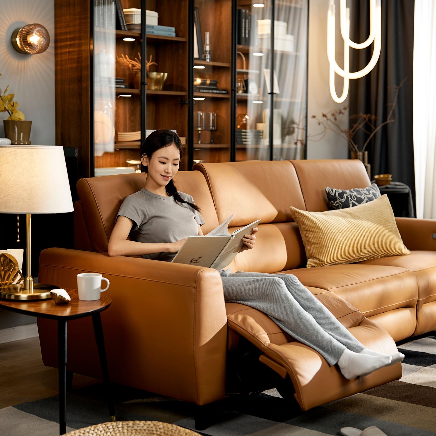 A Grann/Bomstad golden-brown RULLERUM 3-seat sofa w 2 electric recliners in the living room