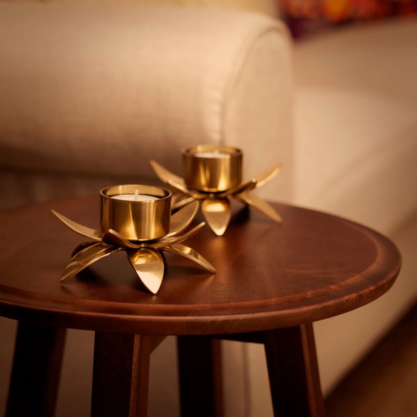 A gold-colour/Lotus AROMATISK tealight holder