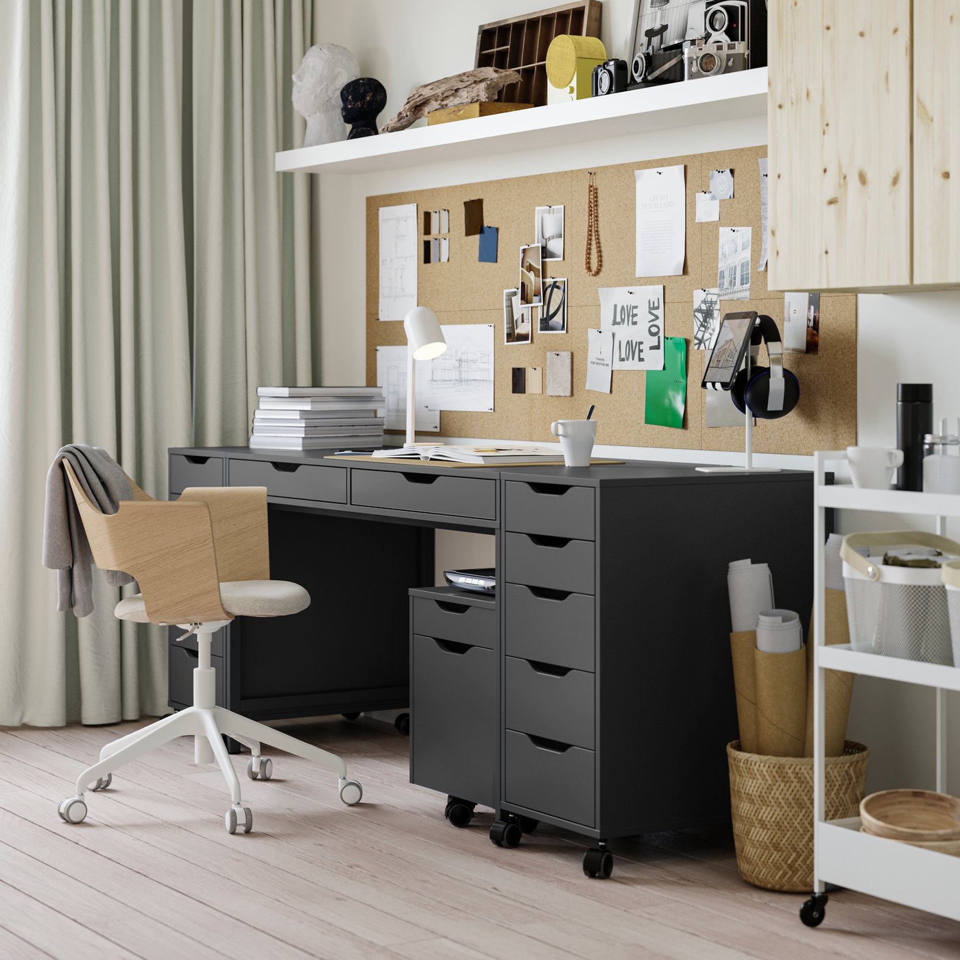 A study corner with ALEX desk and three drawer units in dark grey-black, with a FJÄLLBERGET conference chair in front of it.