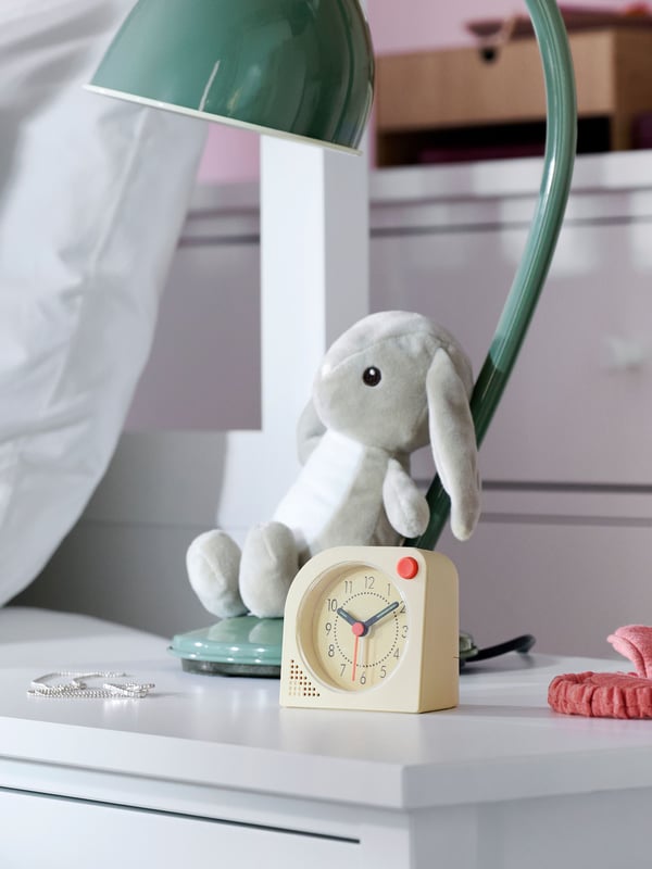 Close-up of GULLABERG bedside table with TJINGA alarm clock, DVÄRGHARE soft toy rabbit and RÖDFLIK desk lamp.