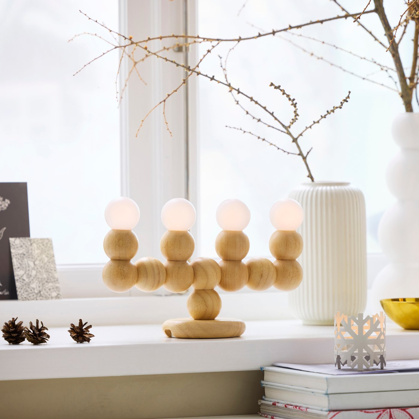 A wood battery-operated STRÅLA LED candelabra
