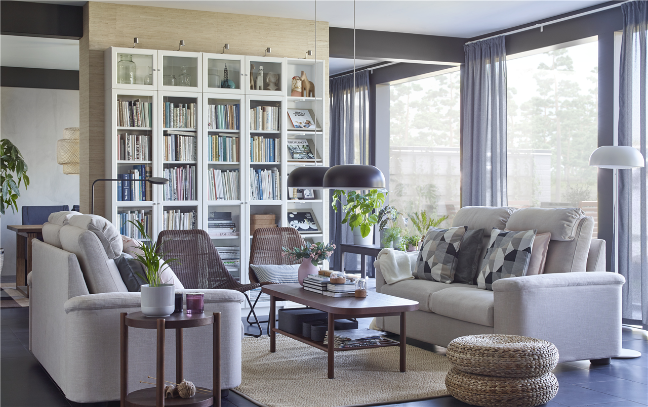 A LIDHULT white couch and a BILLY open cabinet in a fully furnished livingroom