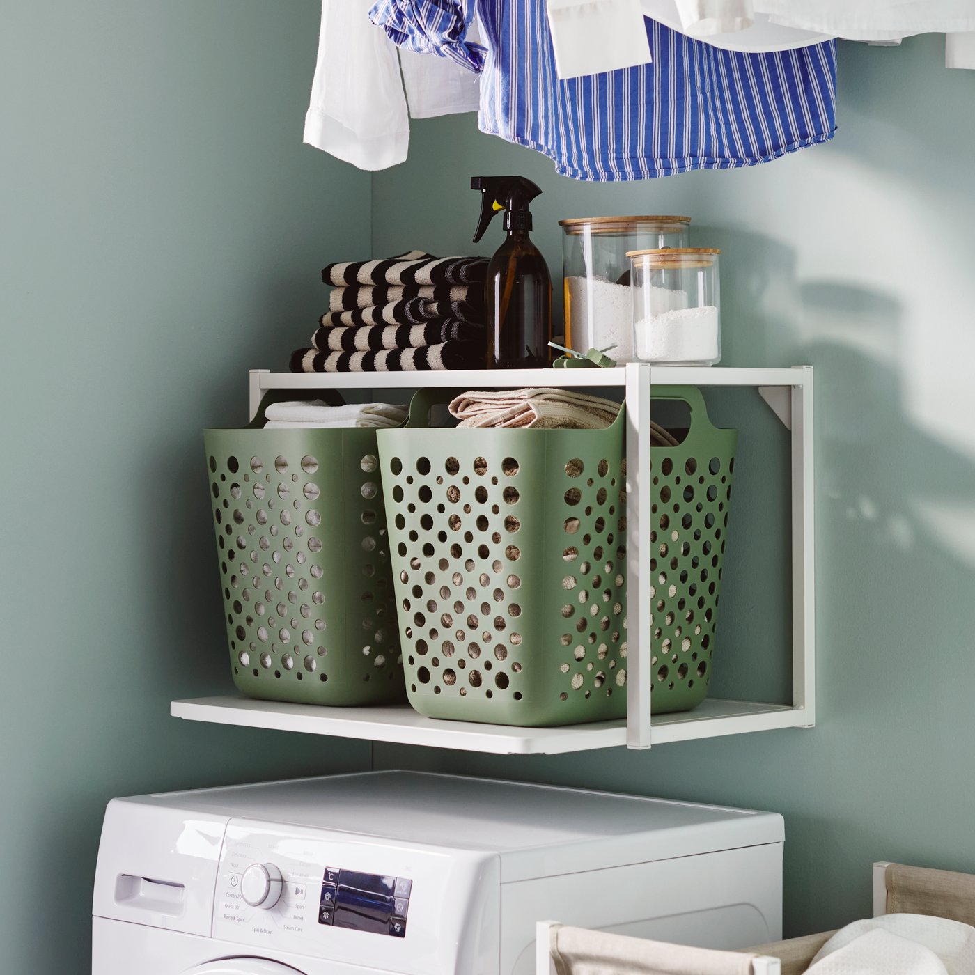 A clear glass/bamboo EKLATANT jar with lid in the laundry room