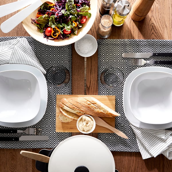 A black LIVNÄRA 24-piece cutlery set in the dining room