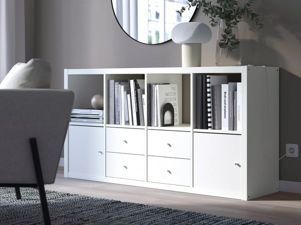 A white KALLAX shelving unit with 4 inserts