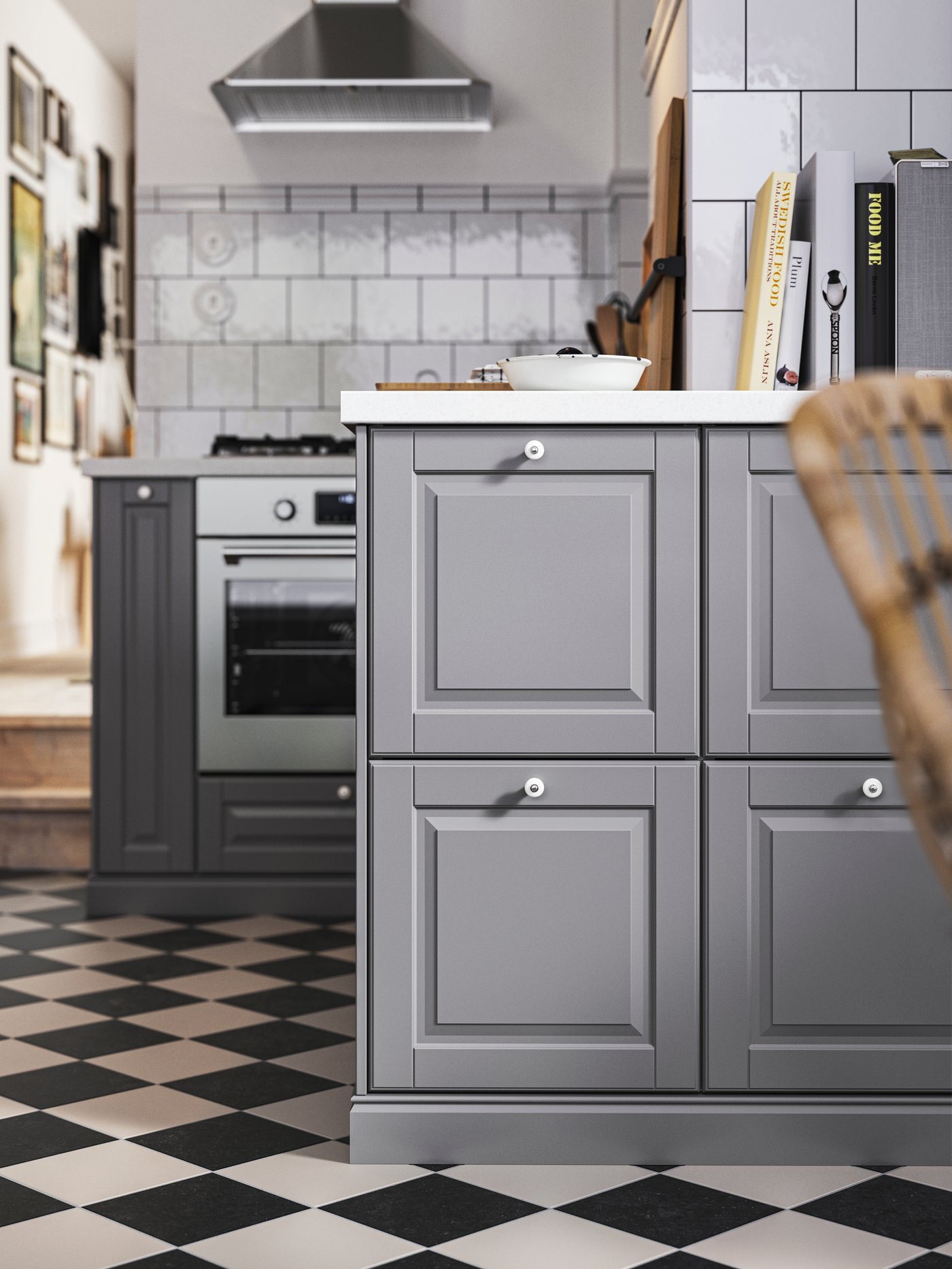 Base cabinets with grey BODBYN kitchen fronts, white/light grey stone effect/laminate worktops and a stainless-steel oven.
