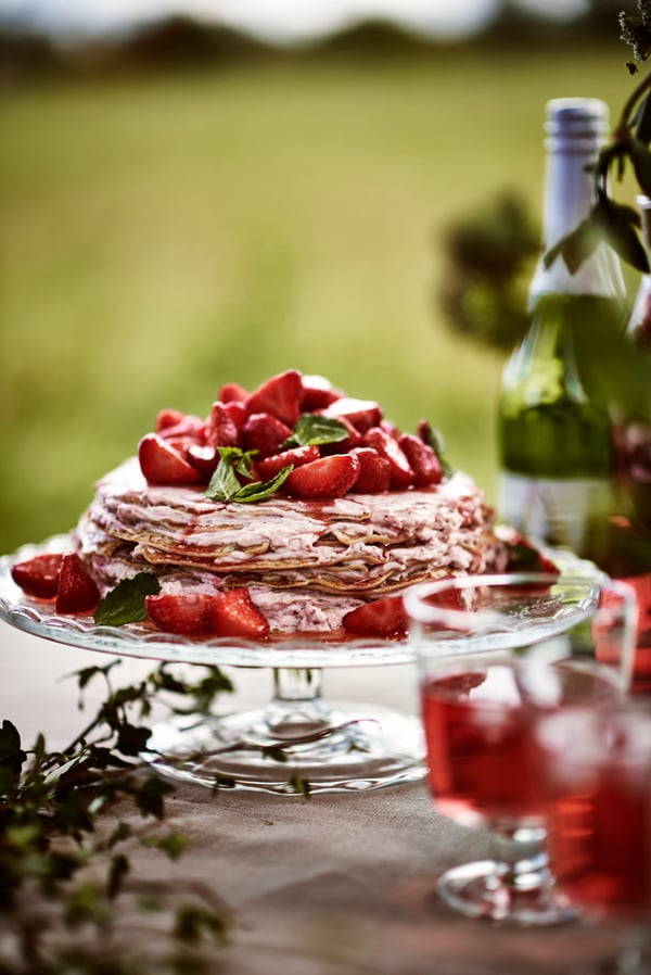 En pannkakstårta med jordgubbar och grädde - perfekt som midsommardessert.