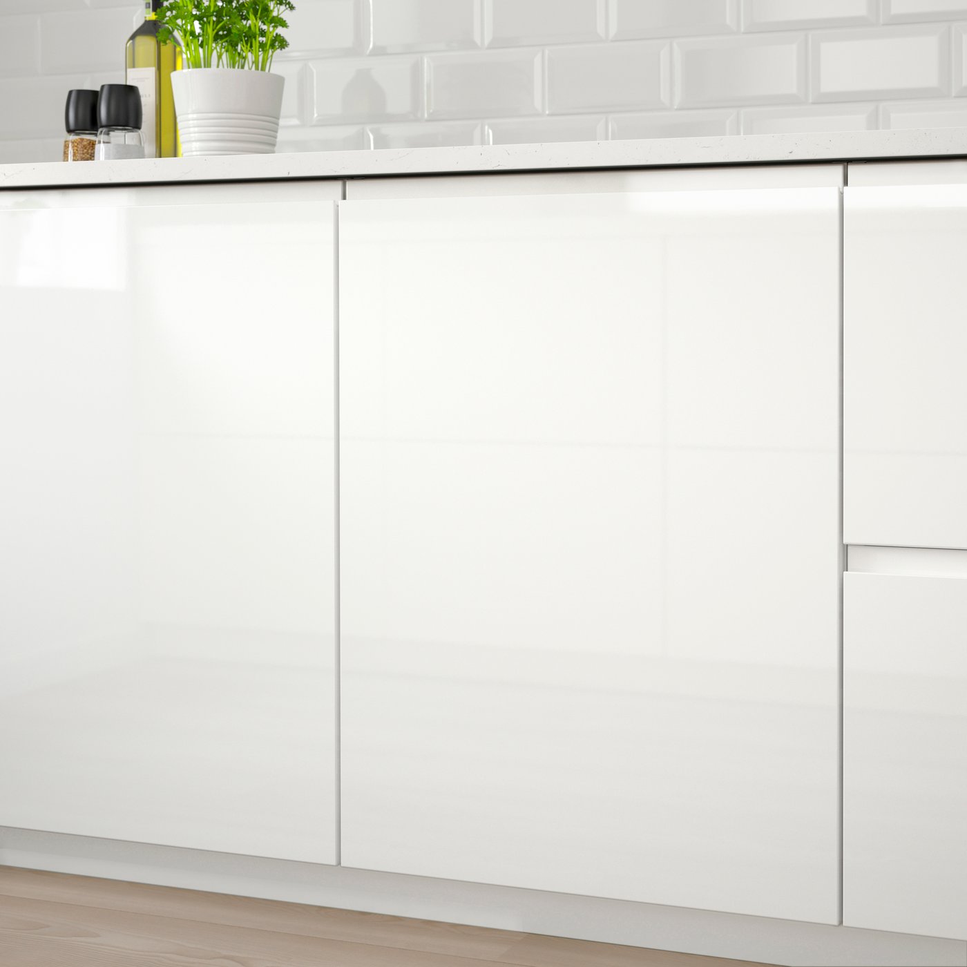 A high-gloss white VOXTORP door
