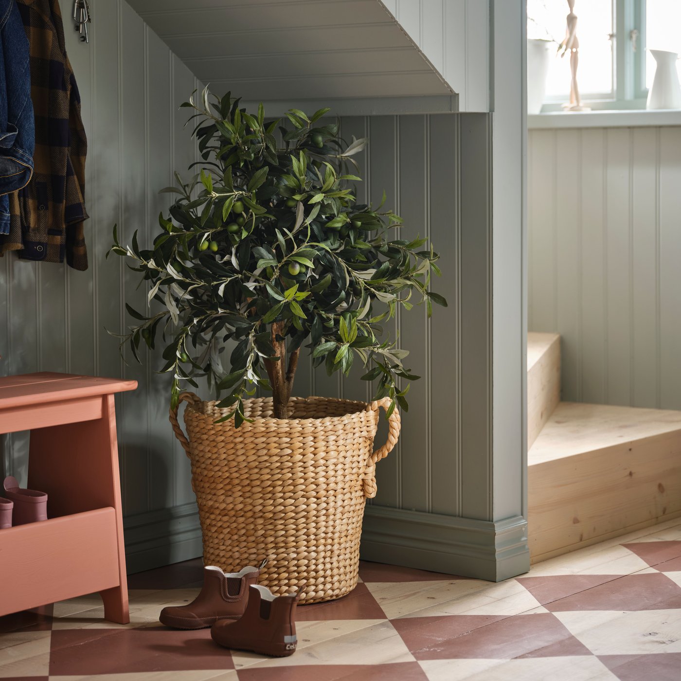 A banana fibre handmade TÖRNBÄR plant pot in the hallway