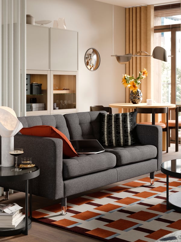 A red-brown DYTÅG cushion cover in the living room