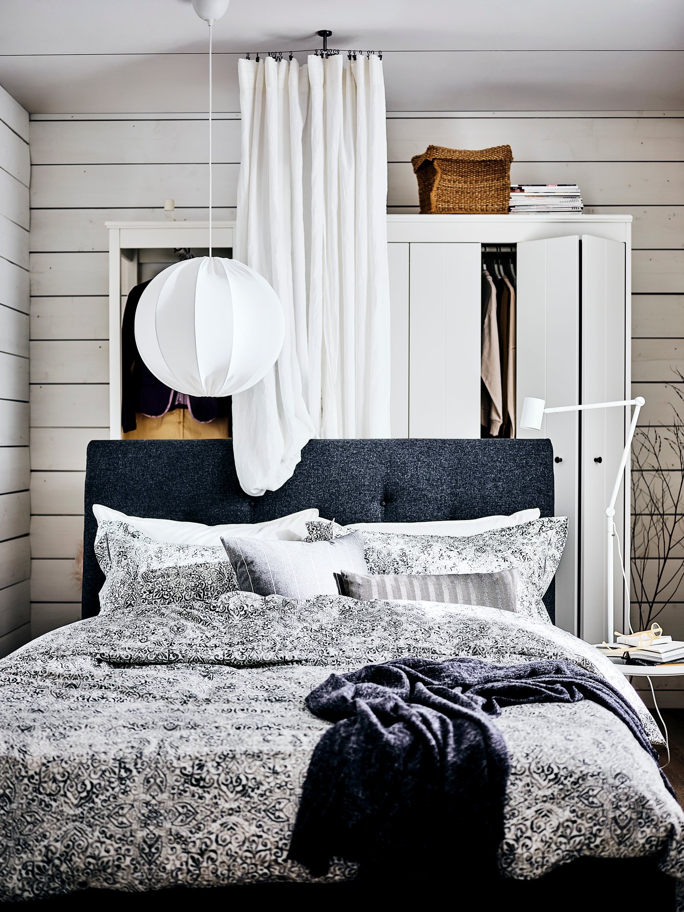 A white REGNSKUR pendant lamp in the bedroom