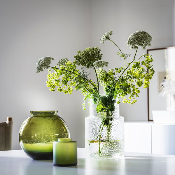 IKEA KONSTFULL clear textured glass vase with two green glass vases on the dining table. 