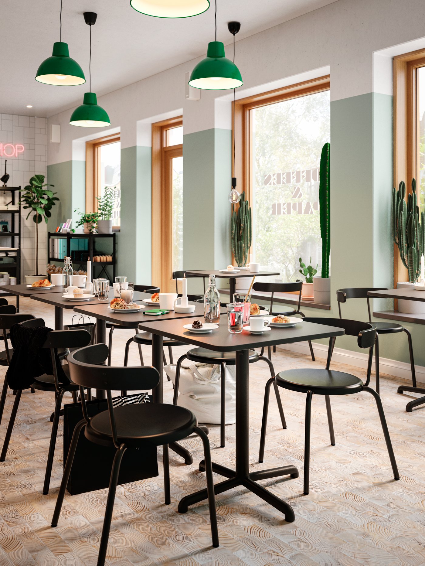 Four anthracite café tables put together to create one long table, coffee and pastries, chairs and dark green pendant lamps.