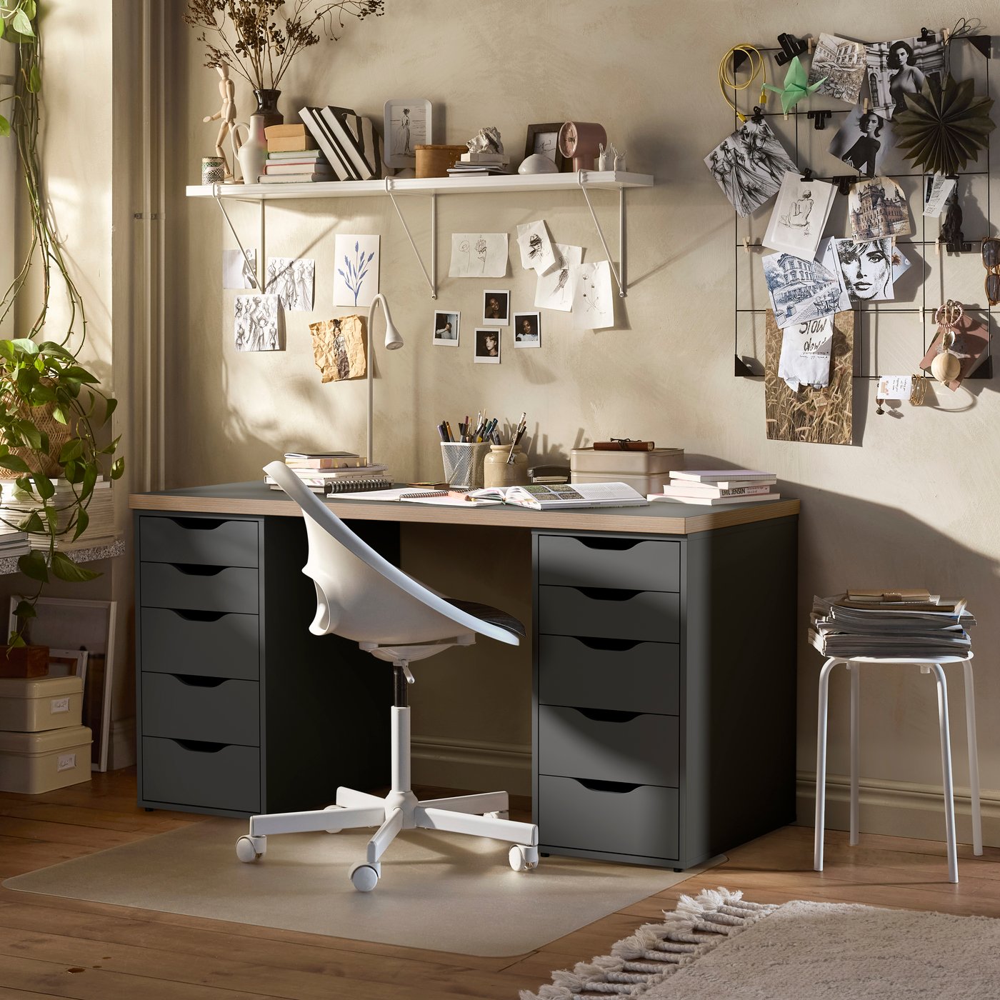 A workspace featuring a grey ALEX desk with drawers on both sides and a white LOBERGET office chair.