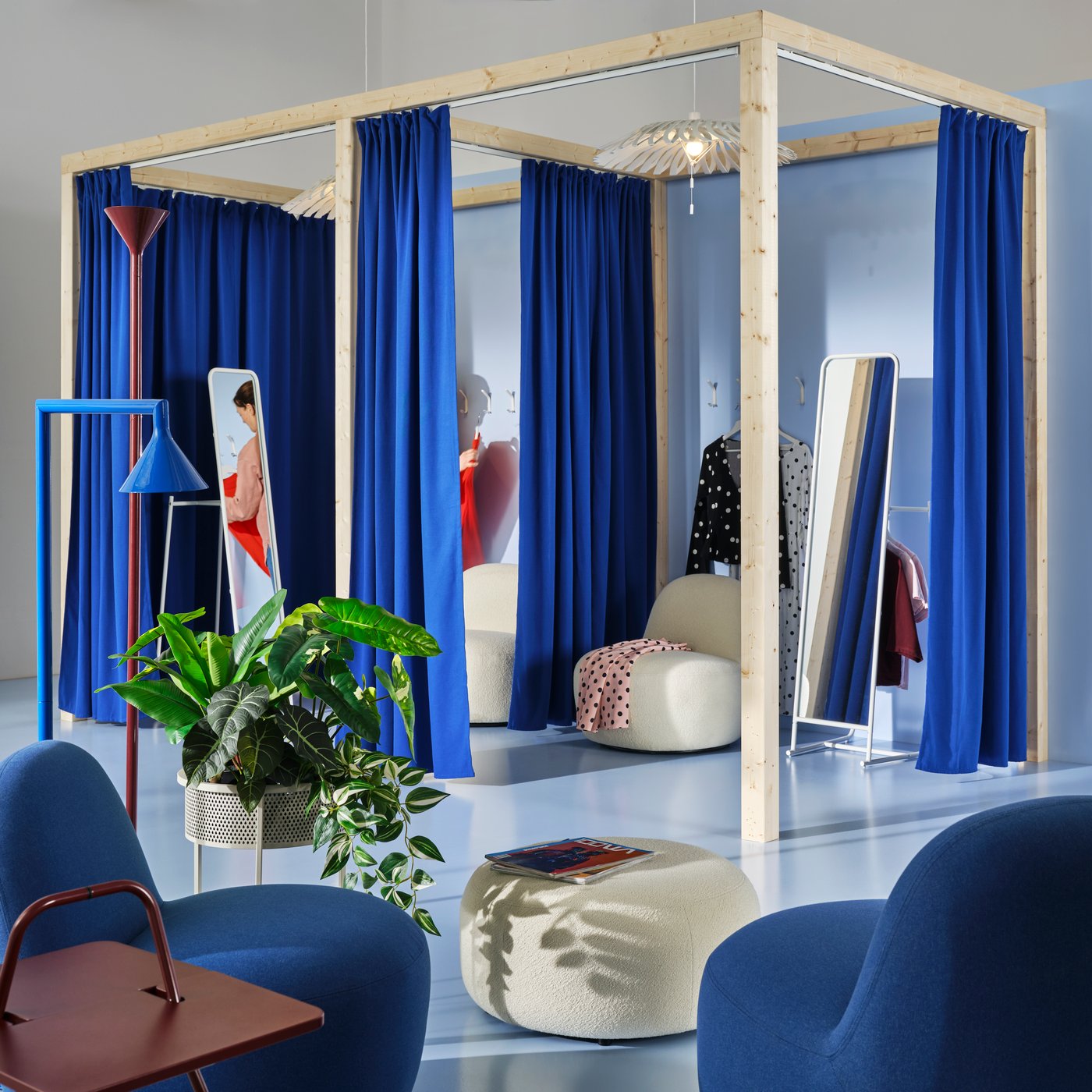 A pop-up store changing area with KNAPPER stand mirror, LILLESÄTER swivel easy chair and pouffe and IKEA PS 2026 uplighter.