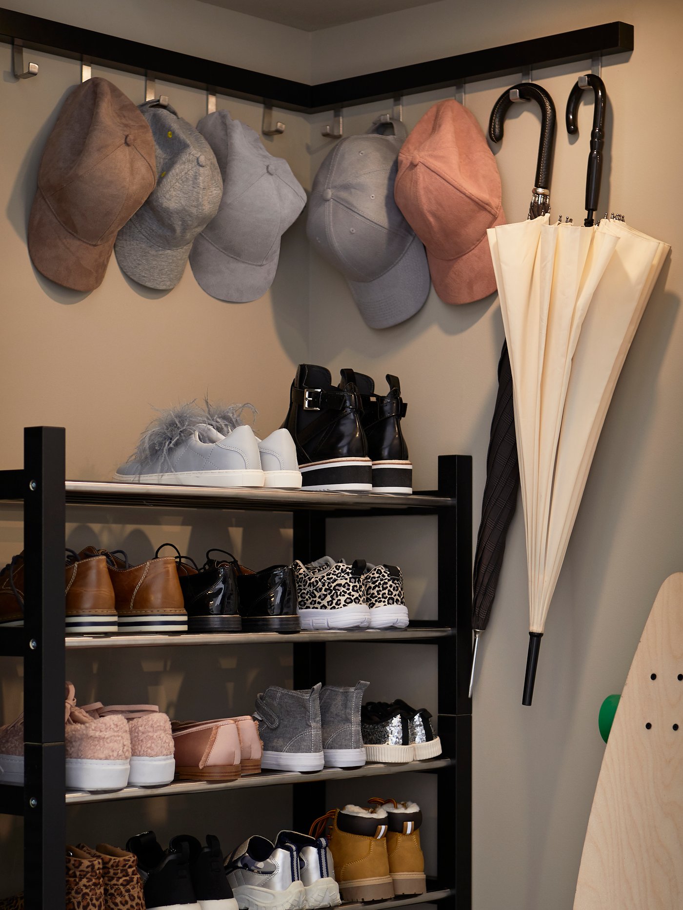Tall black shoe rack full of shoes.