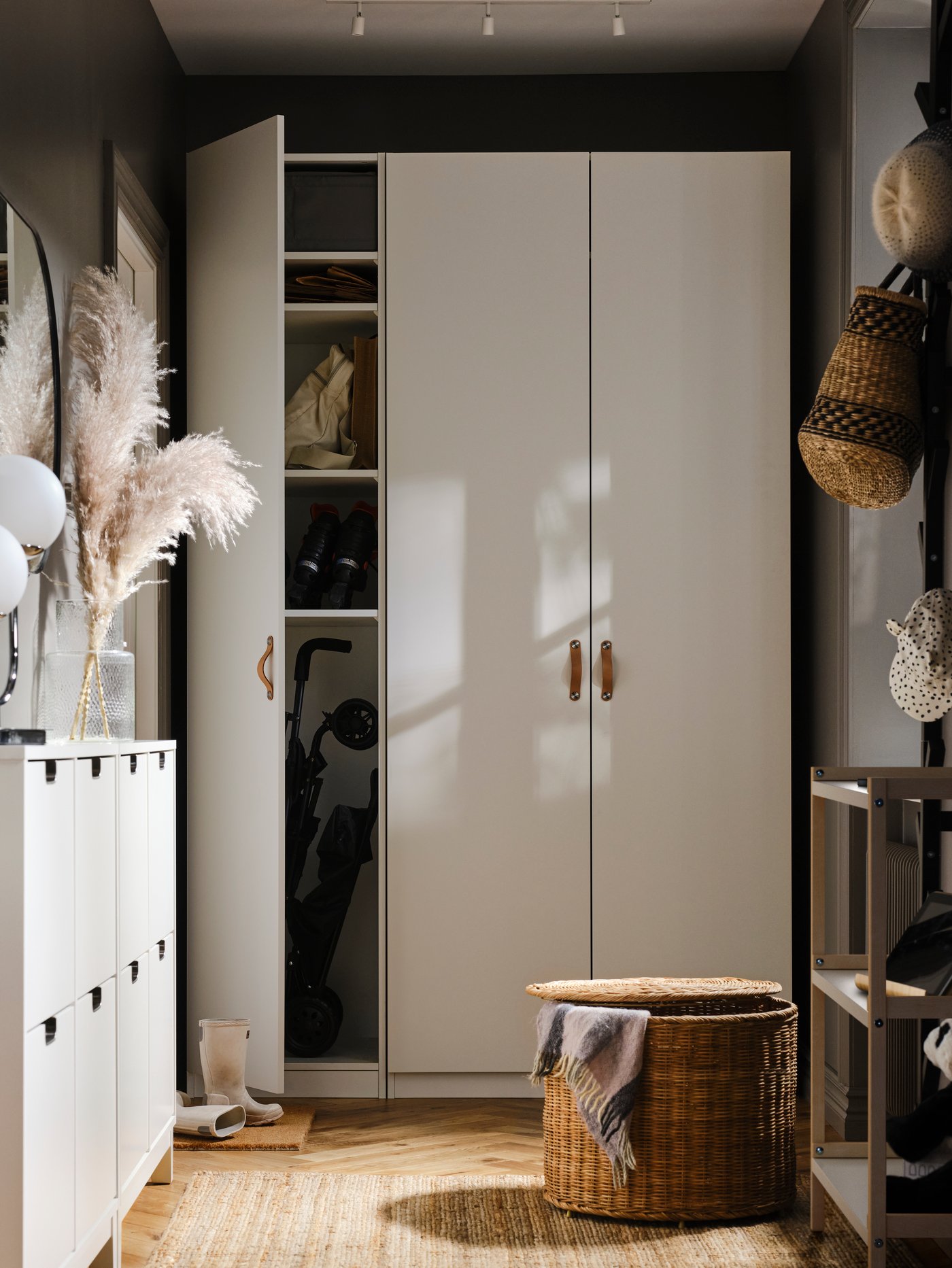 A PAX/FORSAND wardrobe stands at the end of a corridor. A LOHALS carpet lies in front of it. One door of the wardrobe is open.