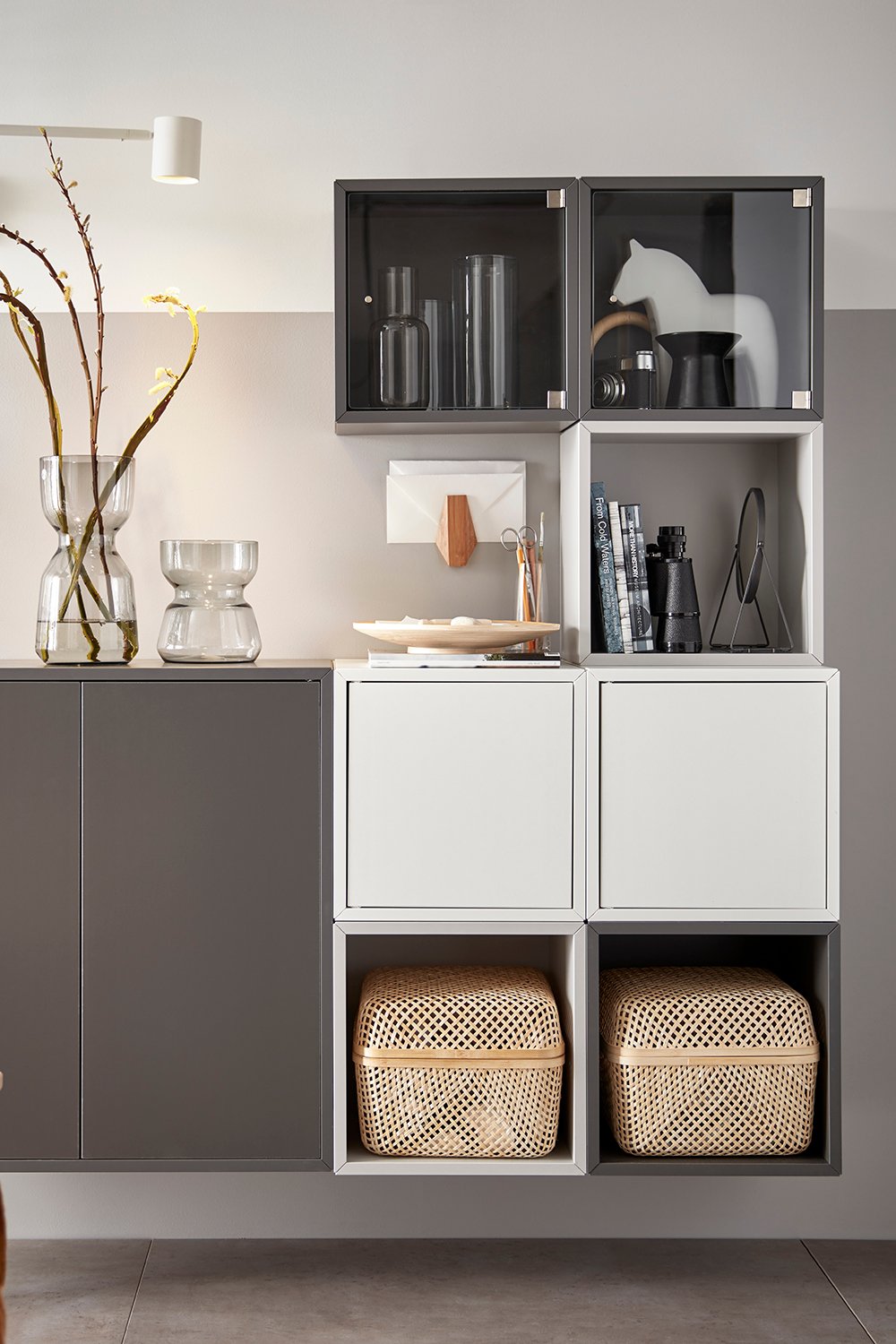 A dark grey EKET cabinet w 2 doors and 1 shelf in the living room