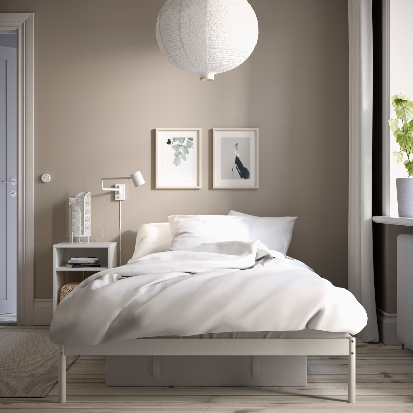 A white VEVELSTAD bed frame in the bedroom