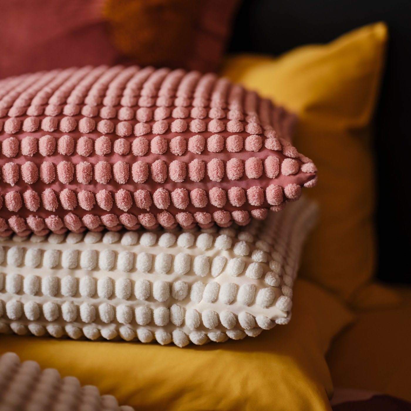 A light pink SVARTPOPPEL cushion cover