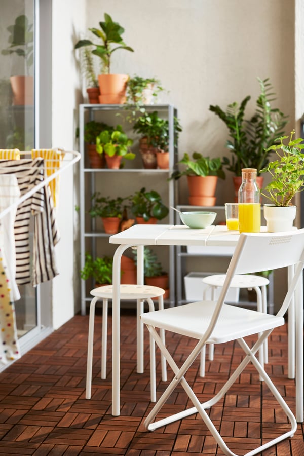 A foldable white FEJAN chair, outdoor outside