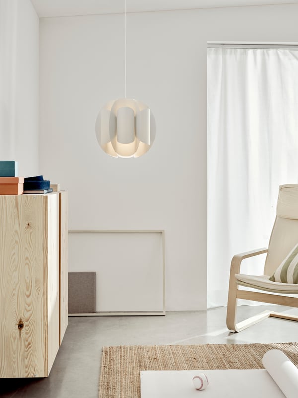 The TRUBBNATE pendant lampshade is displayed as a hero piece in the center of a bright, modern living room.