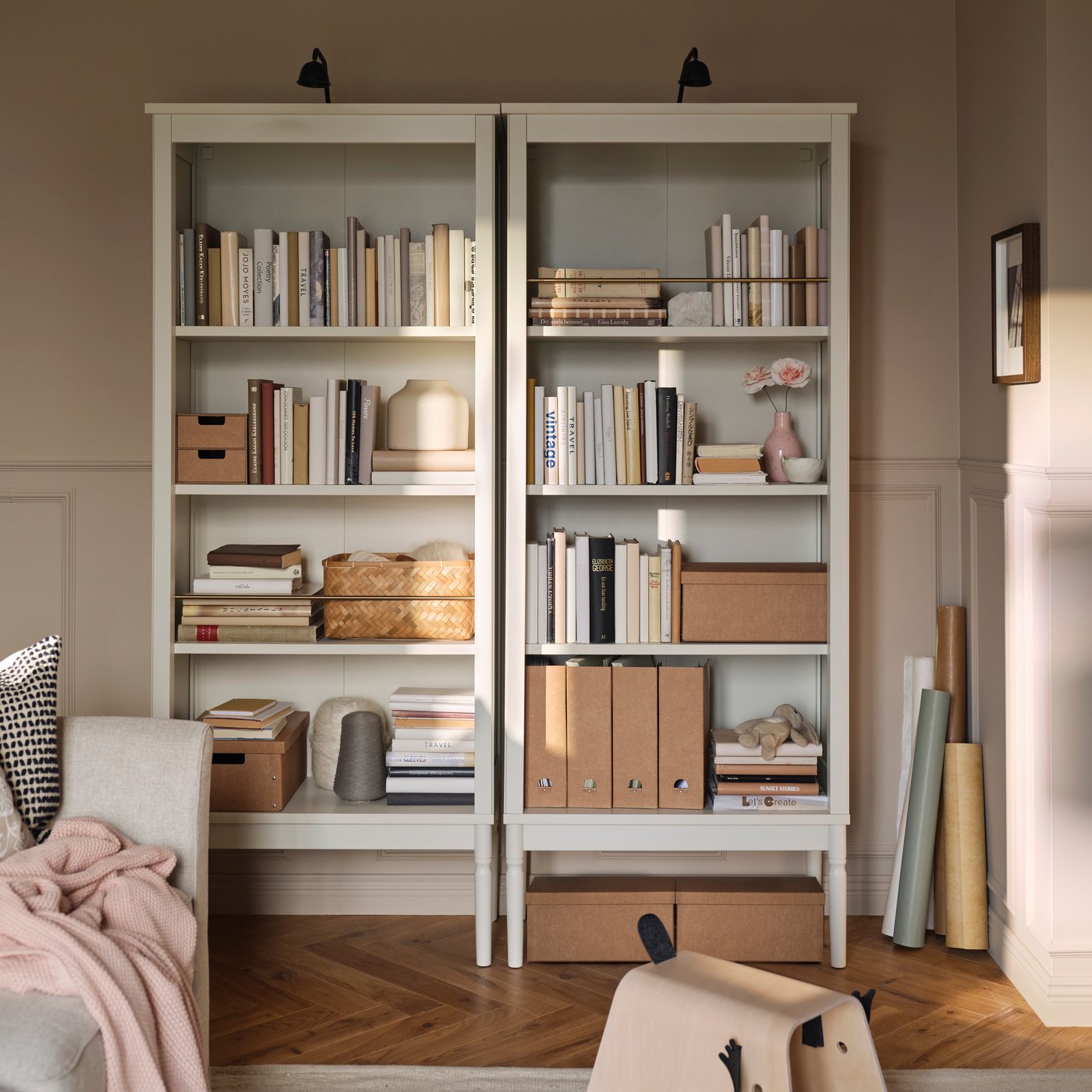 Two FÄRJKARL bookcases with books, GÄRDESGÅRD magazine files and boxes on the shelves and TVÄRDRAG cabinet lighting on top.