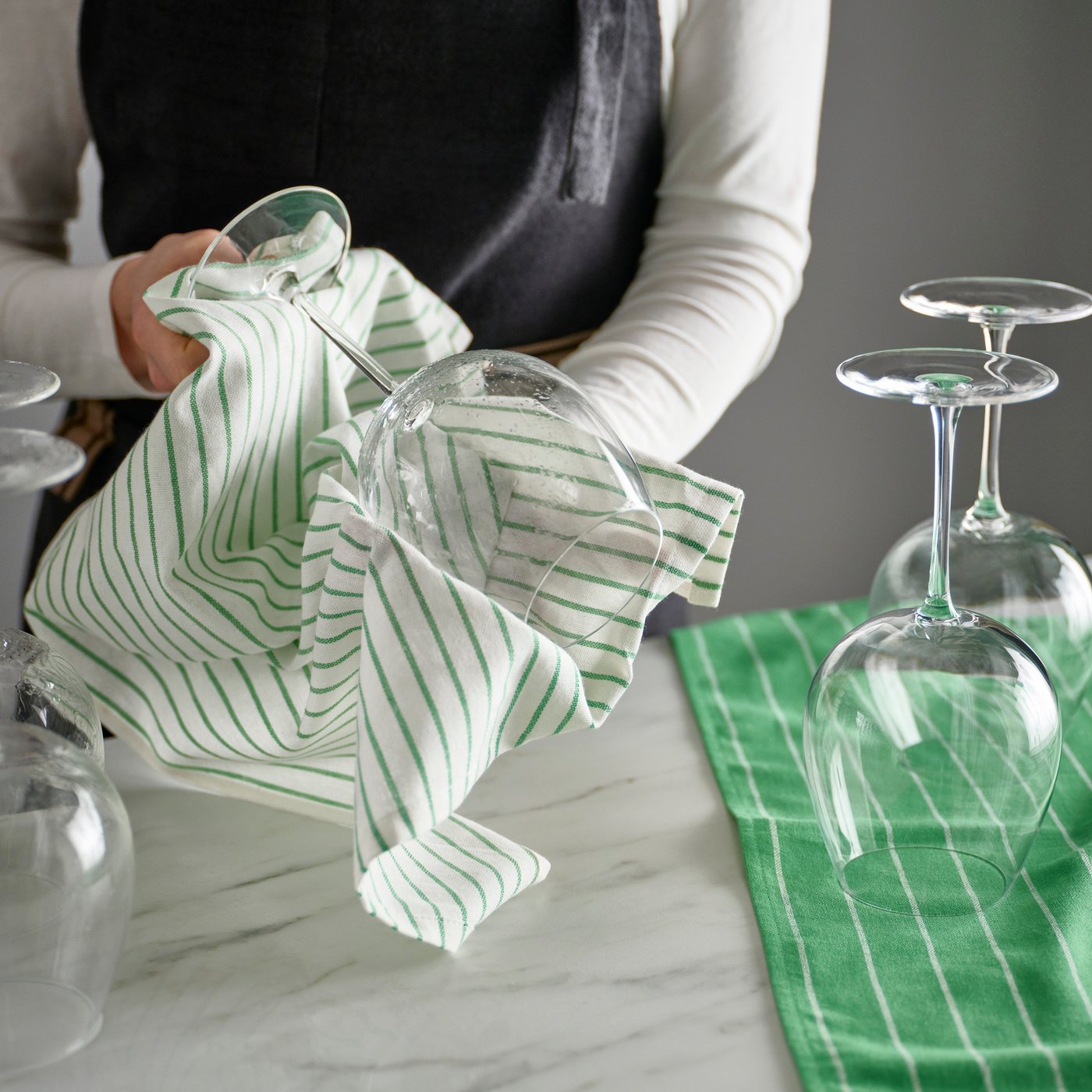 drying wine glasses with tea towel