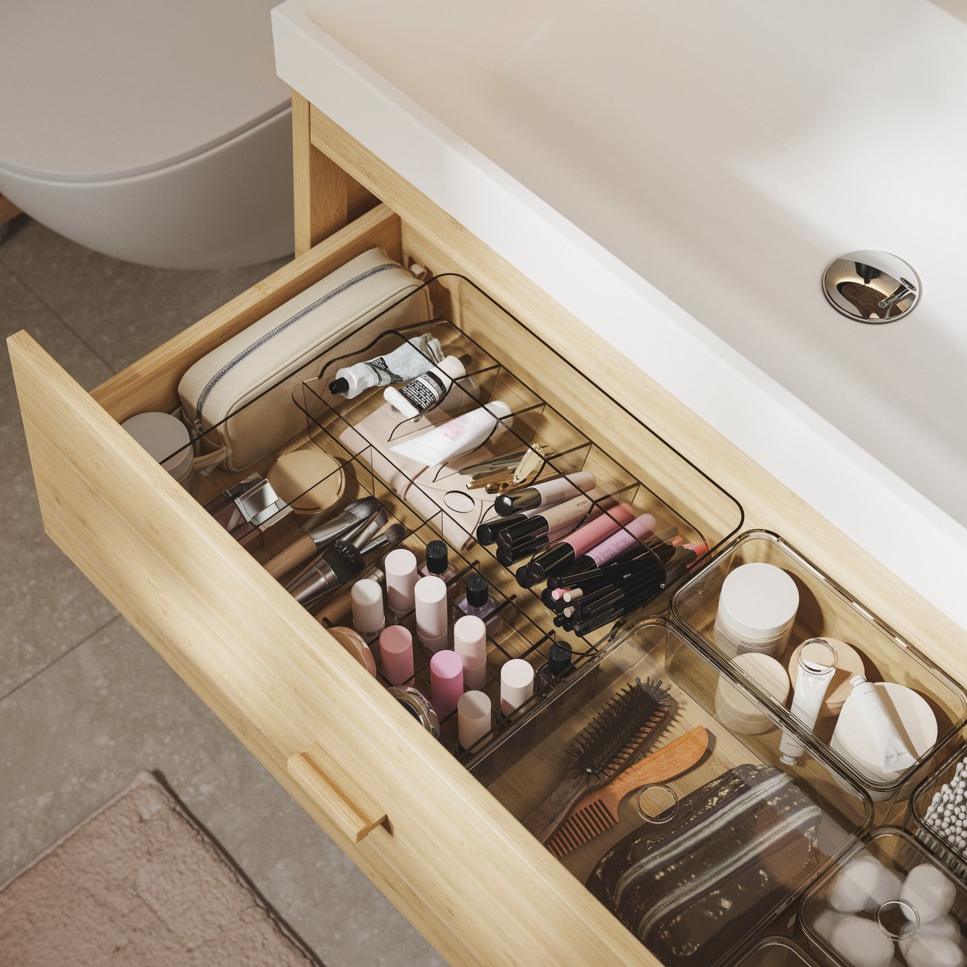 Open drawer filled with organised makeup products such as lipstick, brushes and other beauty tools. Inspiration for in-drawer makeup storage.