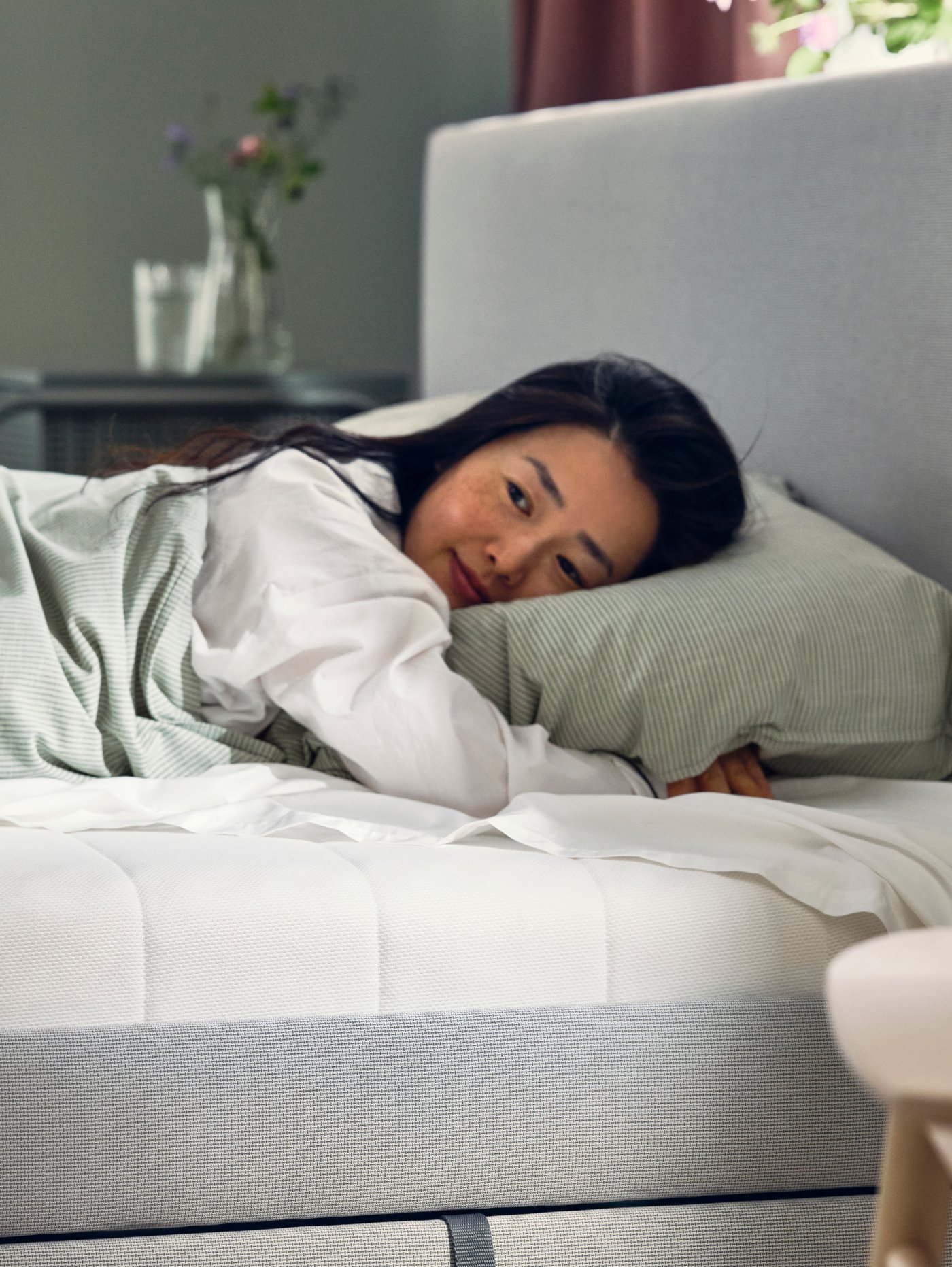 A women laying on a  mattress